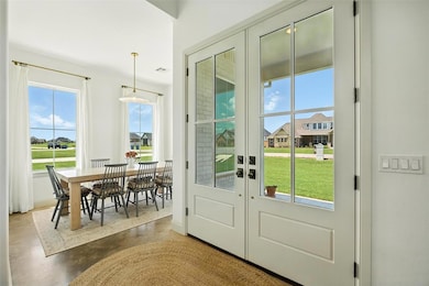 Doorway to outside with french doors and concrete flooring