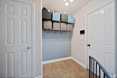 Mudroom with baseboards and light tile patterned flooring