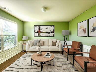 Virtually staged iving room featuring hardwood / w