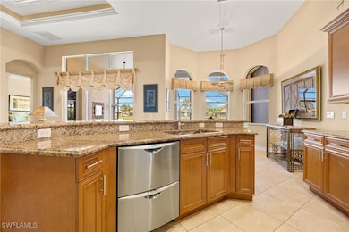 Kitchen with stainless steel dishwasher, a sink, b