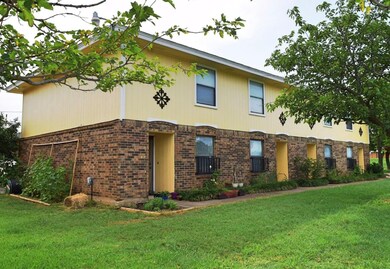View of front facade featuring a front lawn and brick siding