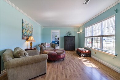 Living room, laminate wood flooring, large windows add lots of natural light