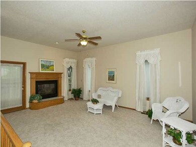 Living Room with gas fireplace & door leading out 