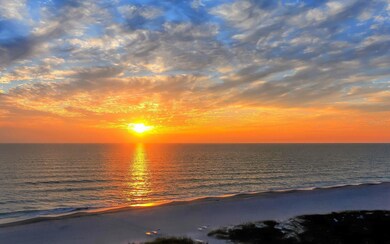 Sunset over the Gulf on the Whispering Sands beach.