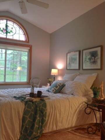 Lovely Master Bedroom features high ceilings and a