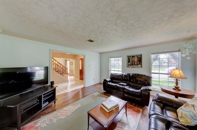 Formal living room has big, bright windows and cro