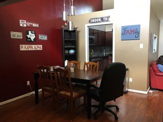 Dining space with wood finished floors and baseboa