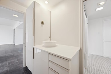 Bathroom with vanity, recessed lighting, and tile patterned flooring