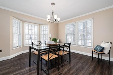 Spacious dining room with another bay window.