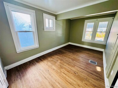 Empty room with baseboards and wood finished floors