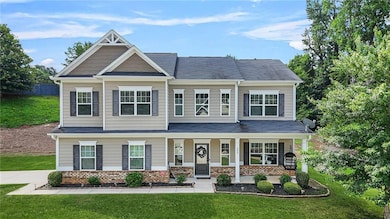 Craftsman inspired home featuring a front lawn, covered porch, brick siding, and a shingled roof