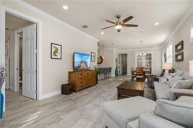 Living room featuring with crown molding, plank ti