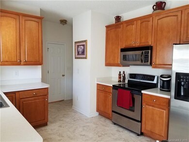 Kitchen w/stainless appliances. Door shown is to a