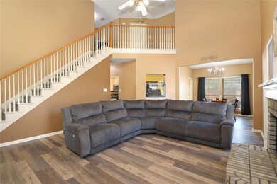 Living room featuring a fireplace, a high ceiling,