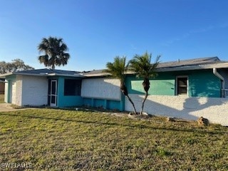 View of side of home featuring a lawn