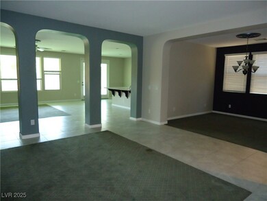 Tiled spare room with arched walkways, a ceiling f