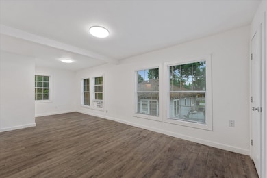 Living space with tons of windows which lets in a