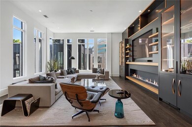 Living room with dark wood finished floors, basebo