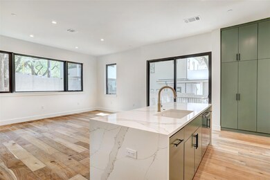 Kitchen featuring green cabinets, a sink, light w