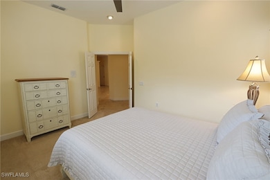 Bedroom featuring baseboards, ceiling fan, light carpet, and visible vents