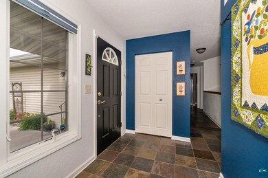 Tiled foyer with a textured ceiling