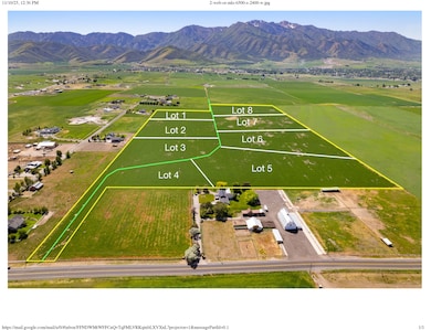 Aerial view of sparsely populated area featuring a mountainous background and property boundaries highlighted