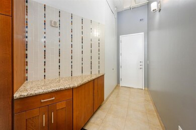 This photo showcases a modern entryway with a tile