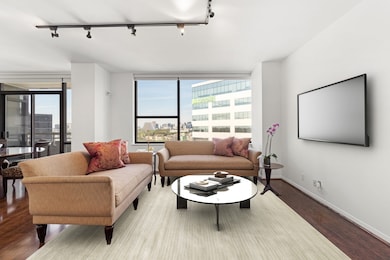 Living room with wood floors, neutral tones, solar shades, art track lighting and Northwest views.