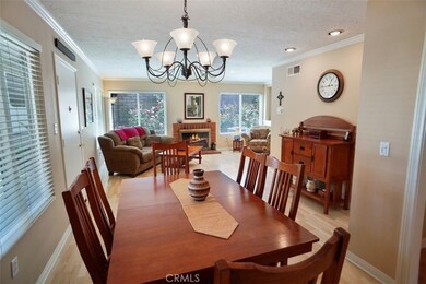dining area to living room with fireplace