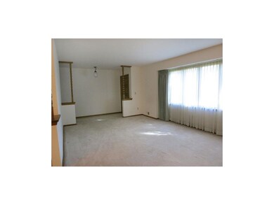 The living room presents a ceiling fan and a large