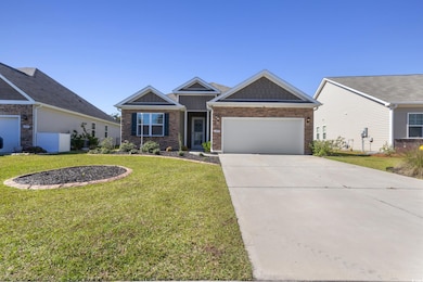 Craftsman house featuring concrete driveway, a front yard, and an attached garage