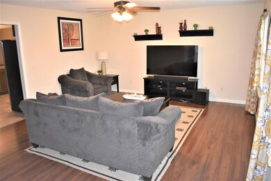 Large living room features tons of natural light and new laminate flooring. 