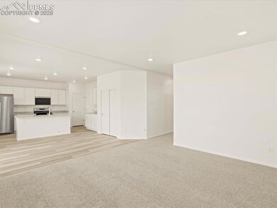 Unfurnished living room with light carpet and recessed lighting