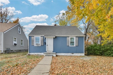 View of front of home featuring a shingled roof and a chimney