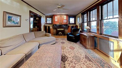Living room with fireplace flanked by glass-front 