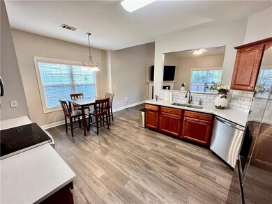 Kitchen with light wood-style flooring, stainless 