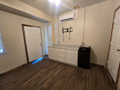 Foyer entrance featuring dark wood-type flooring and a wall mounted air conditioner