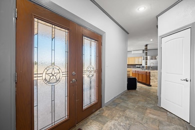 Entrance foyer featuring stone finish floor