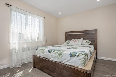 Bedroom featuring wood finished floors and recessed lighting