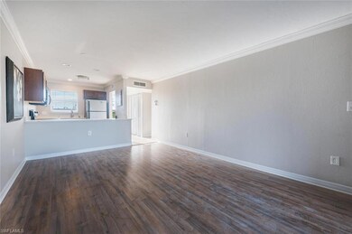 Unfurnished living room featuring ornamental moldi