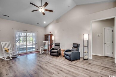Living area featuring ceiling fan, high vaulted ce