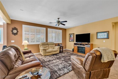 Living room with a ceiling fan and baseboards