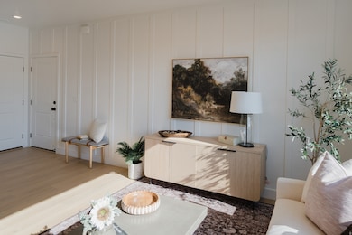 Living area with a decorative wall and wood finished floors