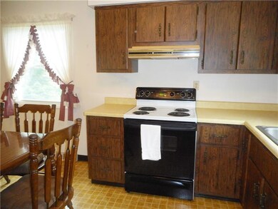 Eat-in kitchen with vinyl flooring.