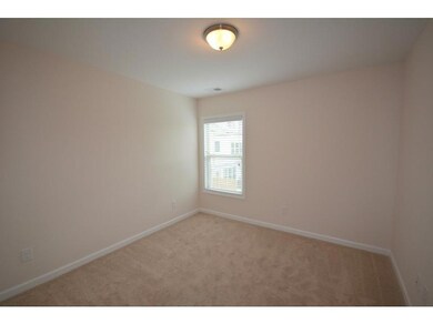 Spare room with light colored carpet and baseboards