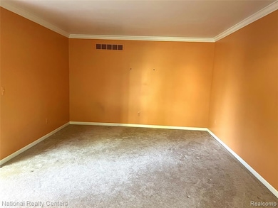 Unfurnished room featuring ornamental molding and carpet floors