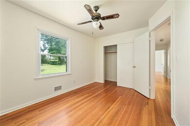 First Bedroom with Hardwood floor and Ceiling fan