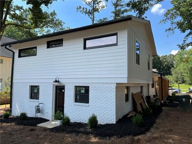 Back of house featuring brick siding