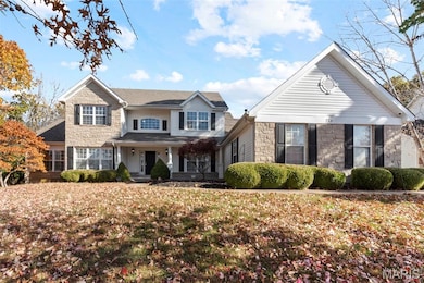 View of front of home featuring stone siding and a porch