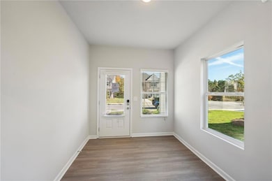 Doorway featuring wood finished floors